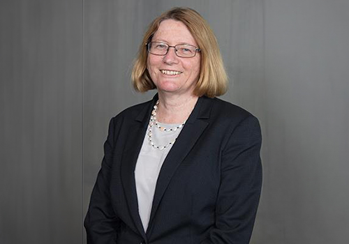A smiling woman in professional clothes