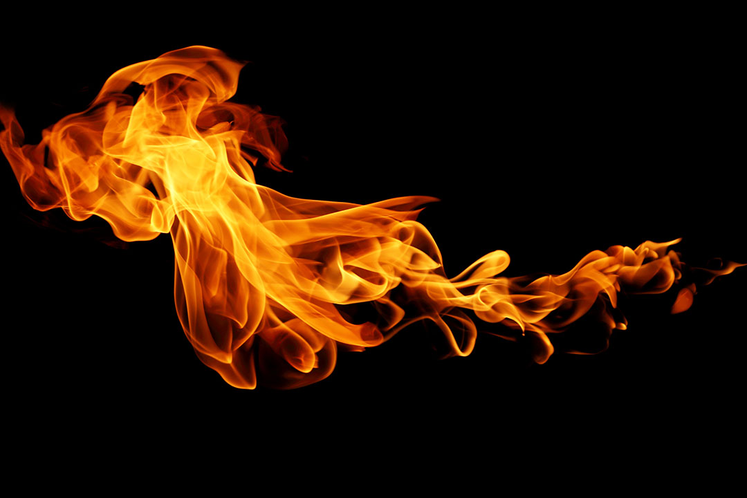 A burst of orange flame against a black background.