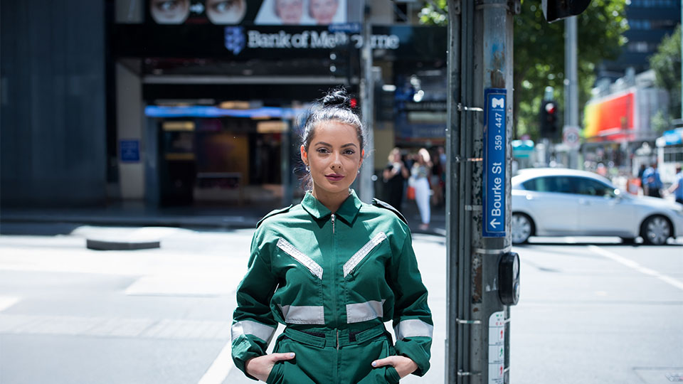 VU Paramedicine student Sarah Maclure stands in uniform on Bourke St in Melbourne.