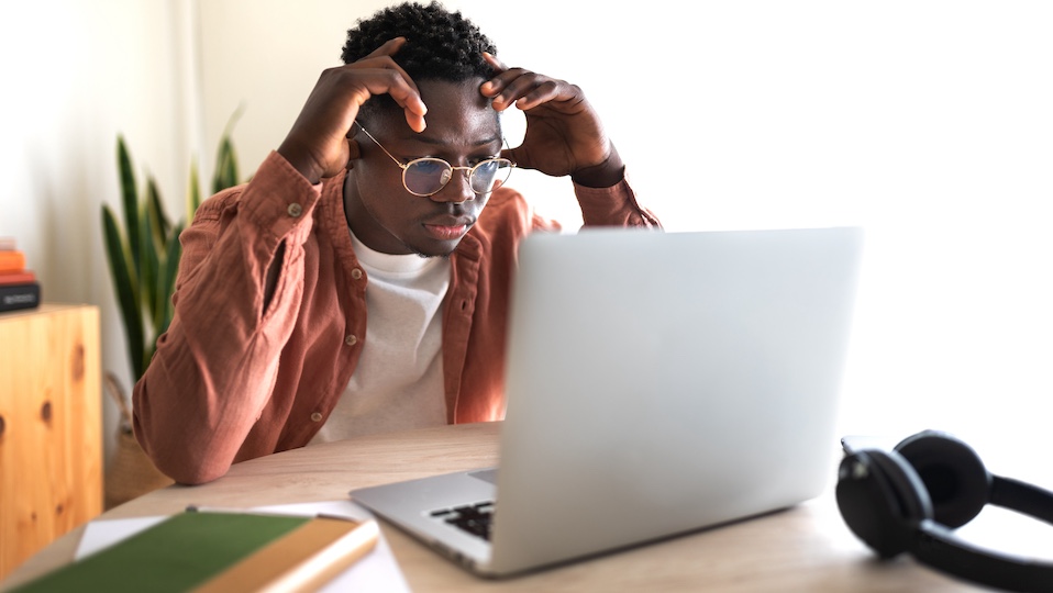 Student looks worried with laptop