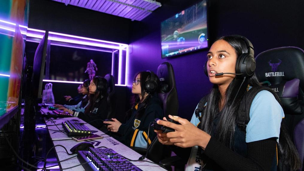Students holding video game controllers 